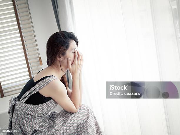 Sad Woman Sitting Alone In Room Stock Photo - Download Image Now - Adolescence, Adult, Bad News