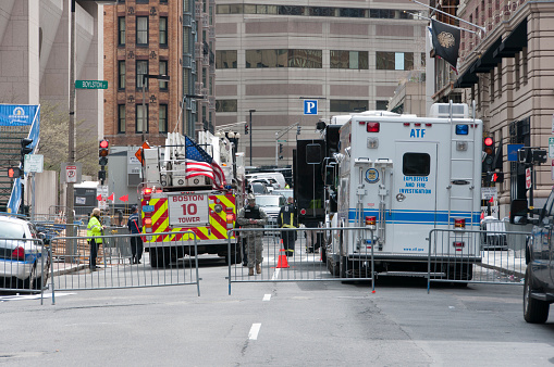 Boston, Massachusetts, United States - April 20, 2013: Exeter St. Boston MA. In Exeter St between Newbury St and Boylston St, we can see some special vehicles and several members of various security, performing research and location of evidence, five days after sustaining the bloody attack that ended with the lives of three people and wounded dozens.