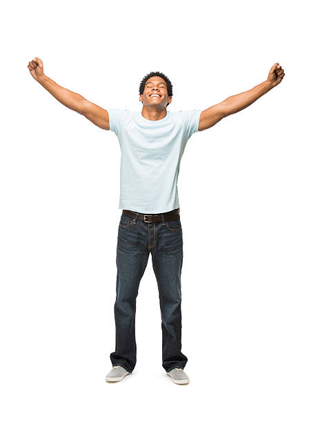 Young latin man holding both arms in the air A young man with both hands in the air showing excitement. Isolated on a white background. arms outstretched stock pictures, royalty-free photos & images