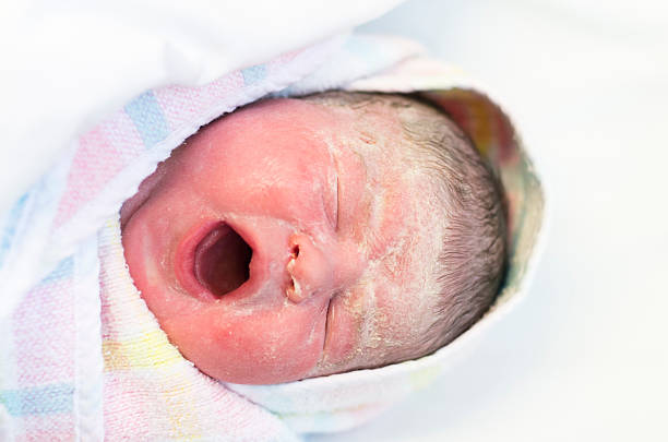 Newborn baby crying stock photo