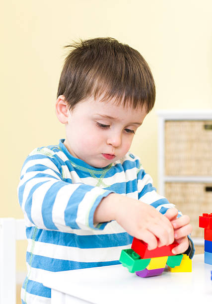 istock Toddler plays with connecting blocks 483634141
