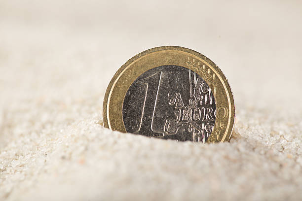 istock Euro coin in the sand 483635710