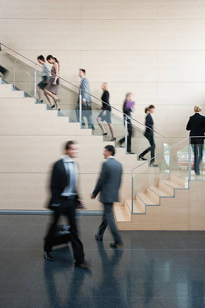 Businesspeople walking on busy office staircase