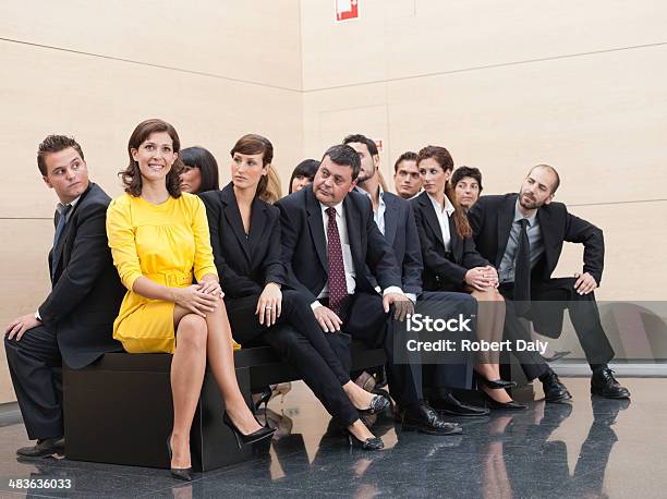 Businesspeople Staring At Unique Coworker Stock Photo - Download Image Now - Standing Out From The Crowd, Envy, Individuality