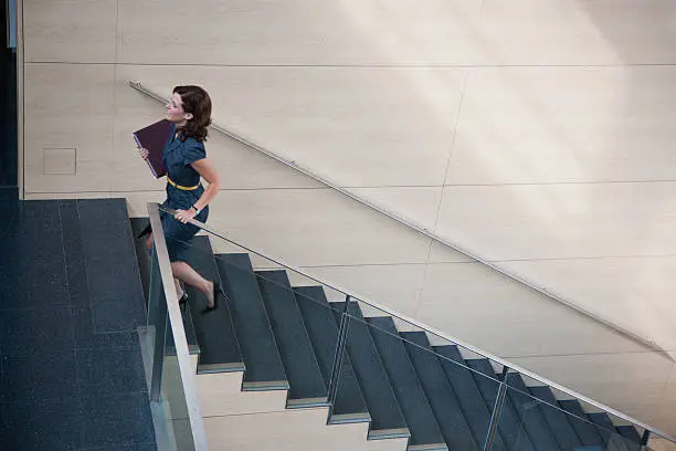 Photo of Businesswoman ascending office staircase
