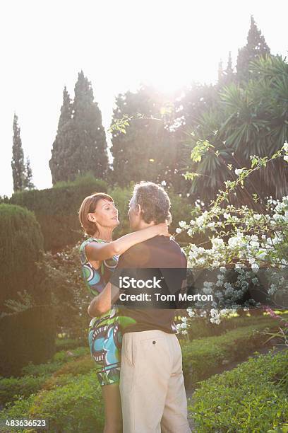Couple Hugging Outdoors Stock Photo - Download Image Now - 40-44 Years, 40-49 Years, 45-49 Years