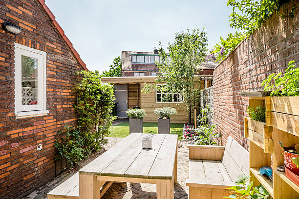 istock Small backyard garden with wooden table and bench 483639440