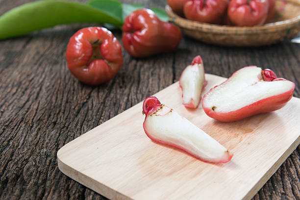 istock slice rose apple on wood plate 483639694
