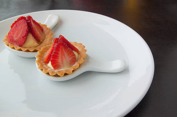 istock Two cheesecake with strawberries on white plate 483643730