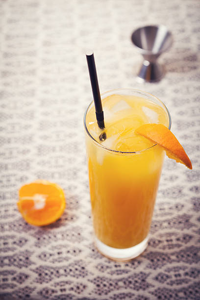 istock Retro orange cocktail drink on lace tablecloth 483644360