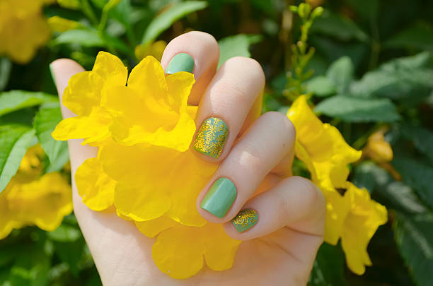 istock Woman hand with sparkle green manicure 483644830