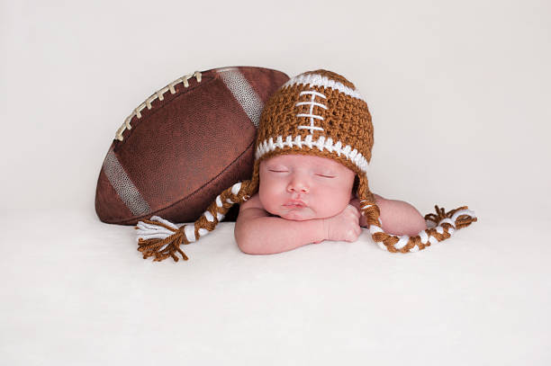 Baby Boy Wearing a Crocheted Football Hat stock photo