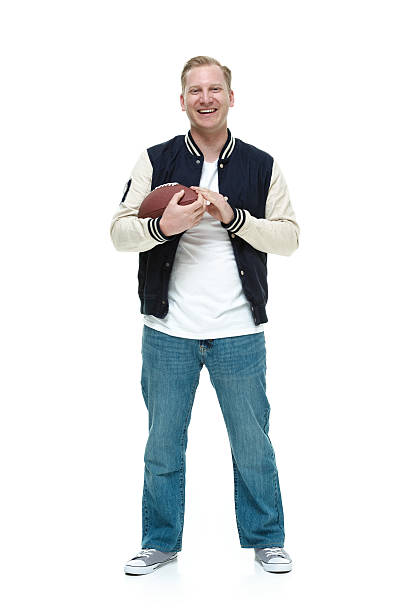 istock Smiling college student holding football 483651754