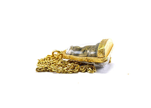 istock Gold necklace withbuddha amulet gold frame isolated on whit background 483654504