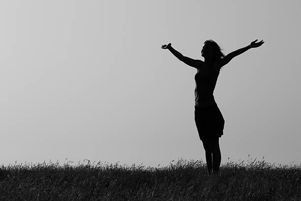 Happy woman enjoys outdoor.Photo is intentionally black and white.