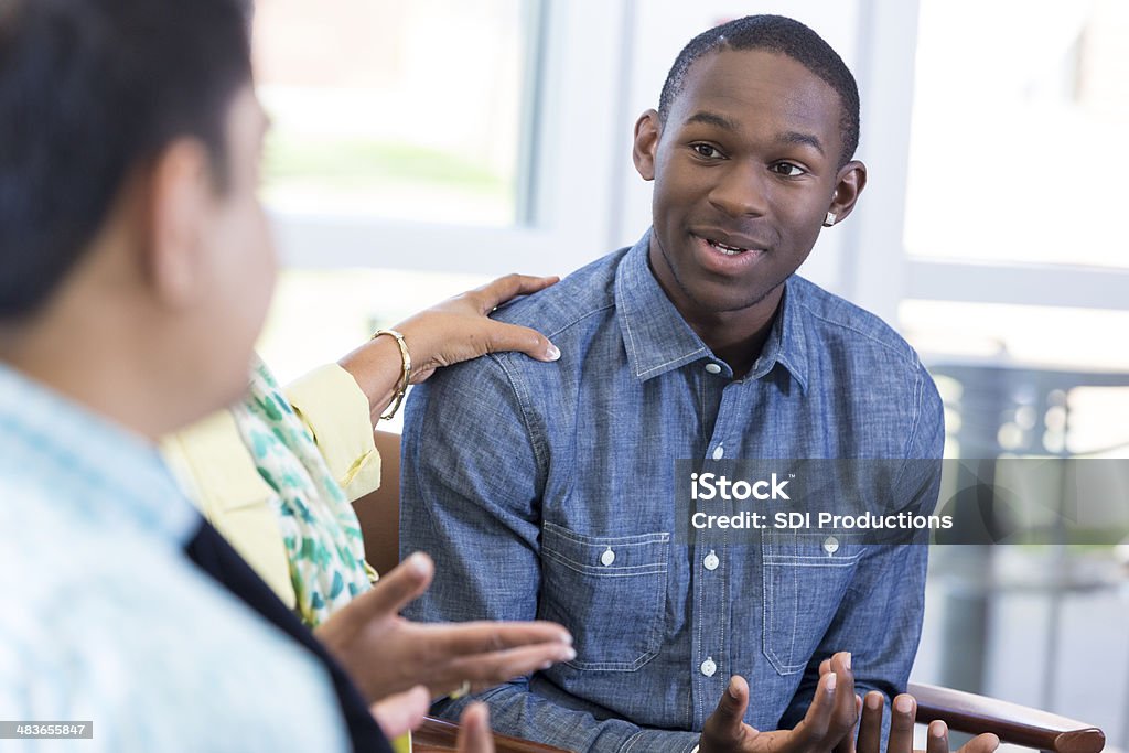 Teenage boy explaining something in group meeting Teenage boy explaining something in group meeting. Teenager Stock Photo