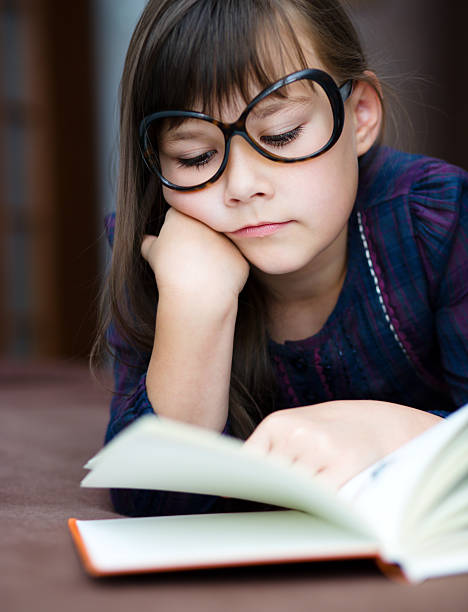 istock Cute girl is reading book 483655950