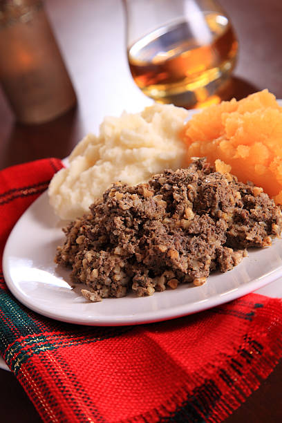 Scottish Burns Night Dinner Scottish Haggis Table Setting For A Burns Night Dinner With A Royal Stuart Tartan Napkin, To Celebrate Scotland's National Poet, Robert Burns haggis stock pictures, royalty-free photos & images