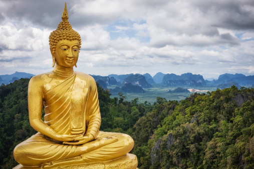 The big golden Buddha statue outdoors and the blue sky looked very beautiful.