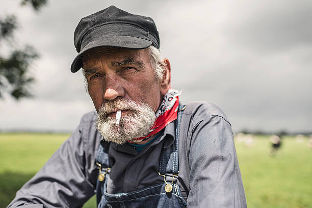 istock Elderly grizzled farmer enjoying a smoke 483659006