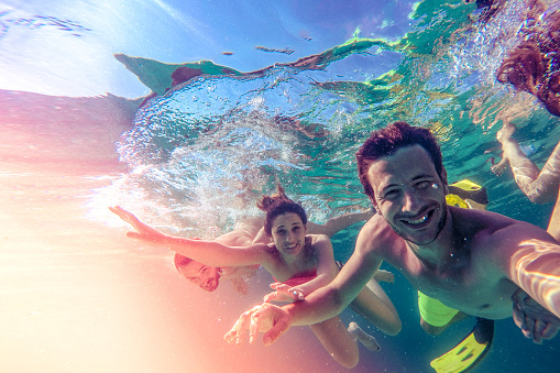 Photo of friends taking an underwater selfie