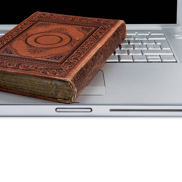 istock Antique old book on a modern laptop 483659626