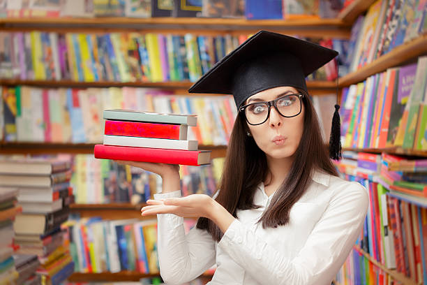 istock Surprised  Student with Graduation Cap Holding Books 483659642