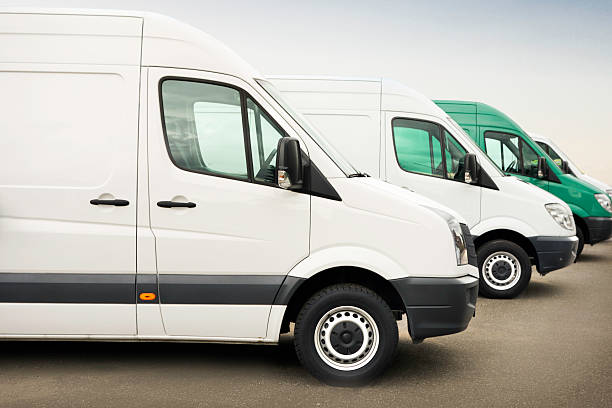 istock Group of white service vehicles parked outdoors 483660433