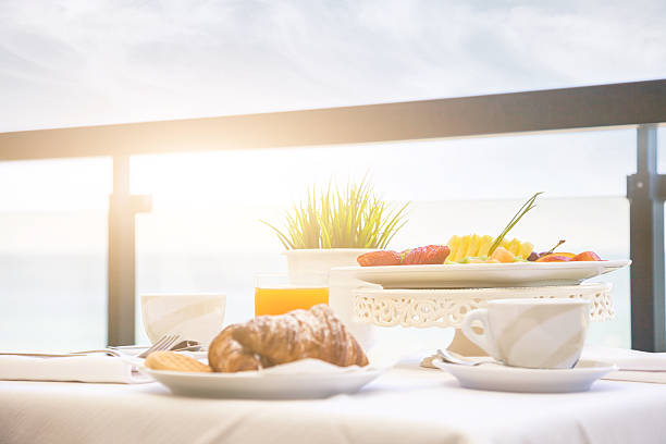 istock Fruit and orange juice in front of the sea 483661953