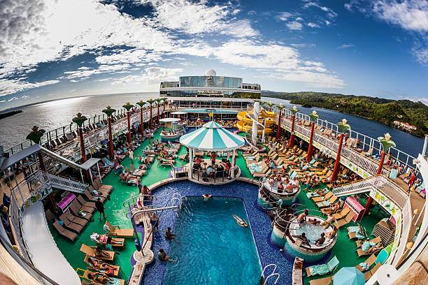 Pool Deck of the Norwegian Gem St. Maarten, Netherlands Antilles - February 02, 2013: A general view of the pool deck of the Norwegian Gem while sailing  near the  St. Maarten coast at Caribbean Sea.  cruise ship people stock pictures, royalty-free photos & images