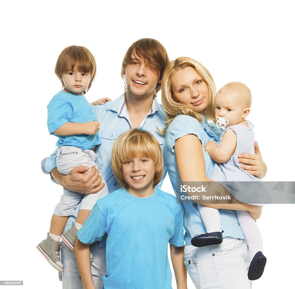 Beautiful parents cute kids Happy young family with holding kids and looking at camera Adult Stock Photo