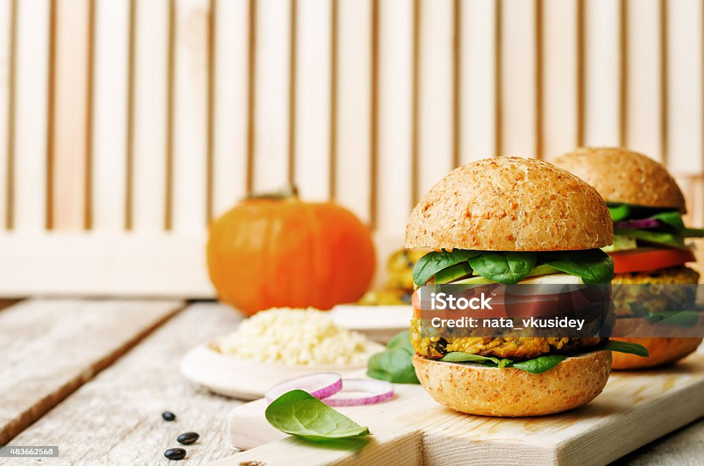 vegan millet black bean pumpkin burgers vegan millet black bean pumpkin burgers on a white wood background. the toning. selective focus 2015 Stock Photo