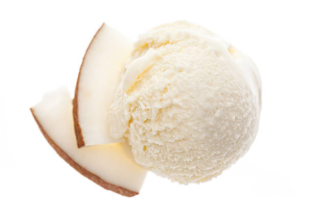 scoop of coconut ice cream with slices of coconut stock photo