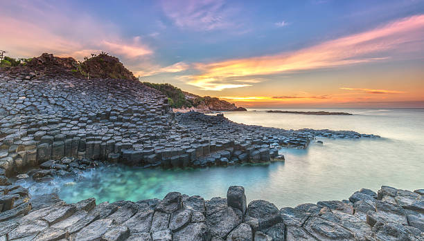 Sunrise on Giant Causeway Sunrise on Giant Causeway, Phu Yen, Vietnam as the sun radiating aura prepared horizon to catch a beautiful new day giants causeway photos stock pictures, royalty-free photos & images