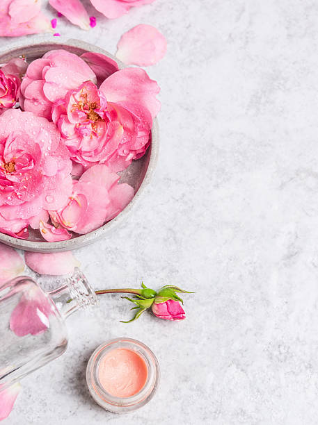 istock Roses in bowl with water , cream  on  stone background 483668666