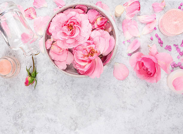 Roses cosmetics set with cream,bottle, petals and sea salt stock photo