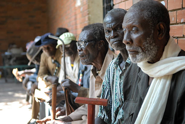 Veterans of Africa Moundou, Chad - October 30, 2012: We can see a group of old African men sitting in them village, thinking of the past. They are old soldier who fight for France in 1959.  chad central africa stock pictures, royalty-free photos & images