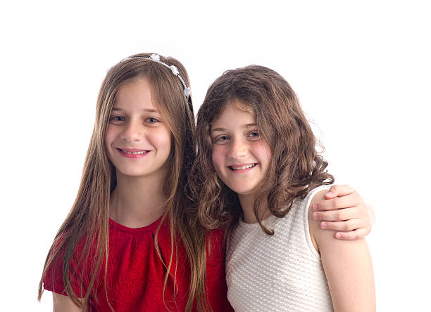 istock beautiful blonde sisters isolated on white 483670319