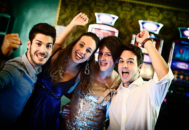 istock Friends gambling on slot machines 483671571