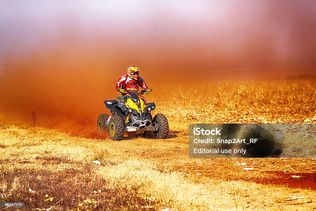 HD- Quad Bike kicking up trail of dust Koster, North West Province, South Africa - July 11, 2015:  Africa-Offroad Racing Rally.  HD - Quad Bike kicking up trail of dust on sand track during rally race. 2015 Stock Photo