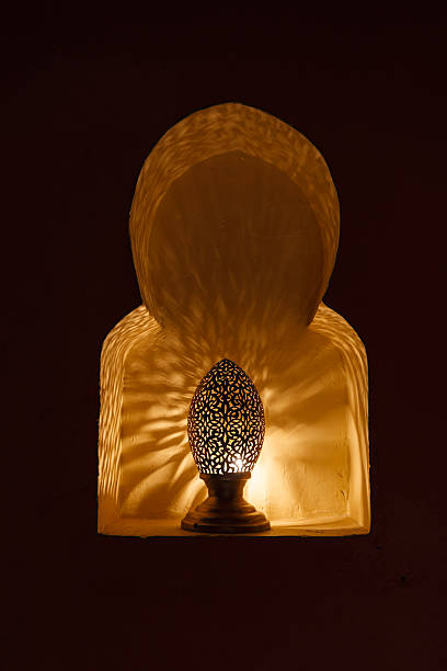istock Traditional moroccan lamp illuminating wall in niche, Morocco 483672736