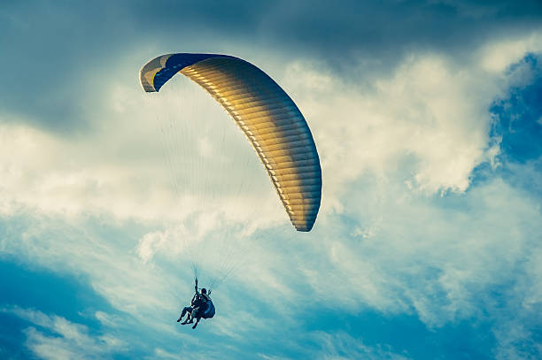istock Paragliding extreme Sport with blue Sky and clouds on background 483673041