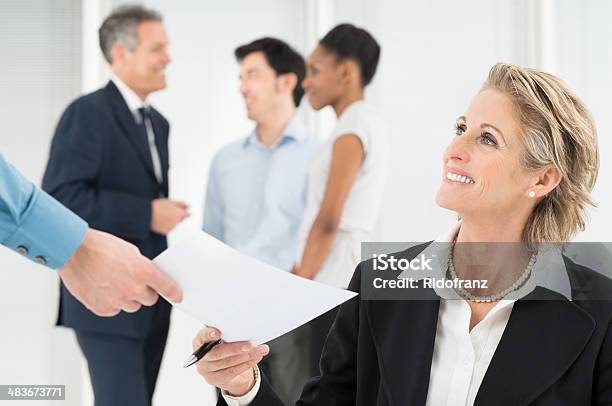 Happy Businesswoman Holding Document Stock Photo - Download Image Now - Business Meeting, 40-49 Years, 50-59 Years