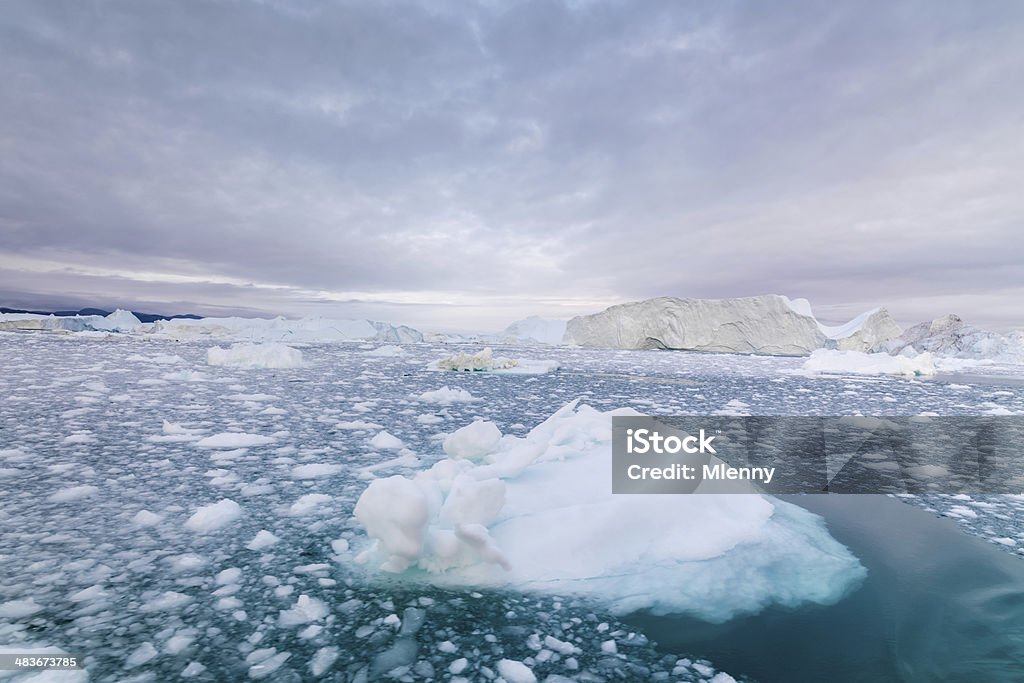 Greenland Arctic Icebergs Ilulissat Arctic Iceberg at sunset in the arctic ocean under beautiful sky. Ilulissat, Greenland. Hasselblad 50MPixel XXXL File. Arctic Stock Photo