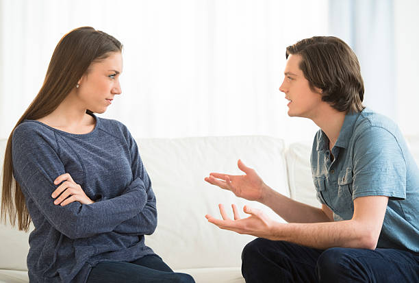 istock Man Explaining Woman While Arguing In Living Room 483674643