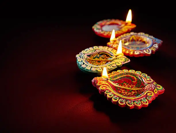 Colorful clay diya lamps lit during diwali celebration