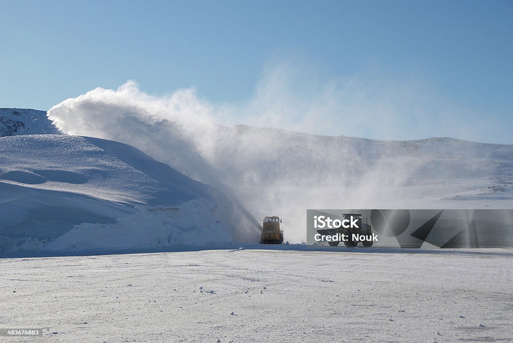 Snow machines A snowblower and tractor cleaning a landing area Construction Industry Stock Photo