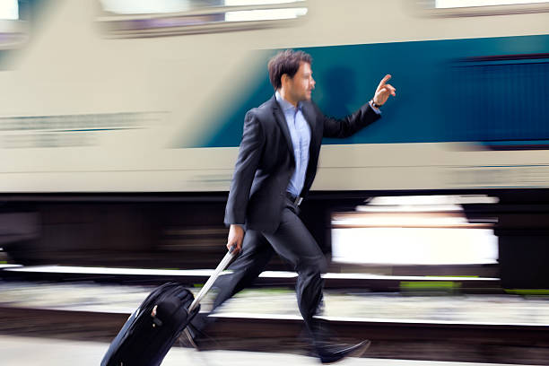 istock Businessman  with roller case Running For Train on Station Platform 483677879