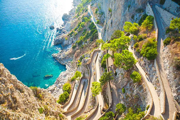 Cliff with a path leading to the sea. Capri, Campania, Italy.