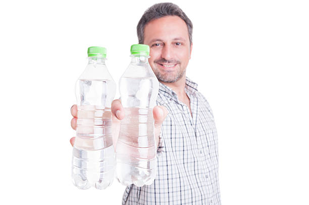 istock Man offering bottles of cold water 483684186